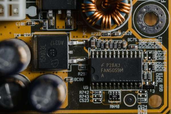 Detailed view of microchips and components on a motherboard circuit board.