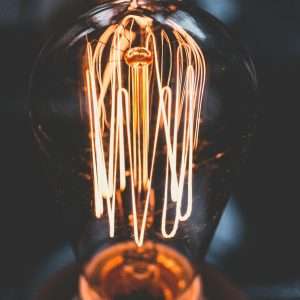 A mesmerizing close-up of a glowing vintage Edison light bulb with warm illumination.