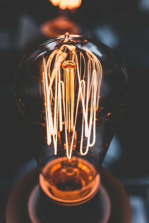 A mesmerizing close-up of a glowing vintage Edison light bulb with warm illumination.